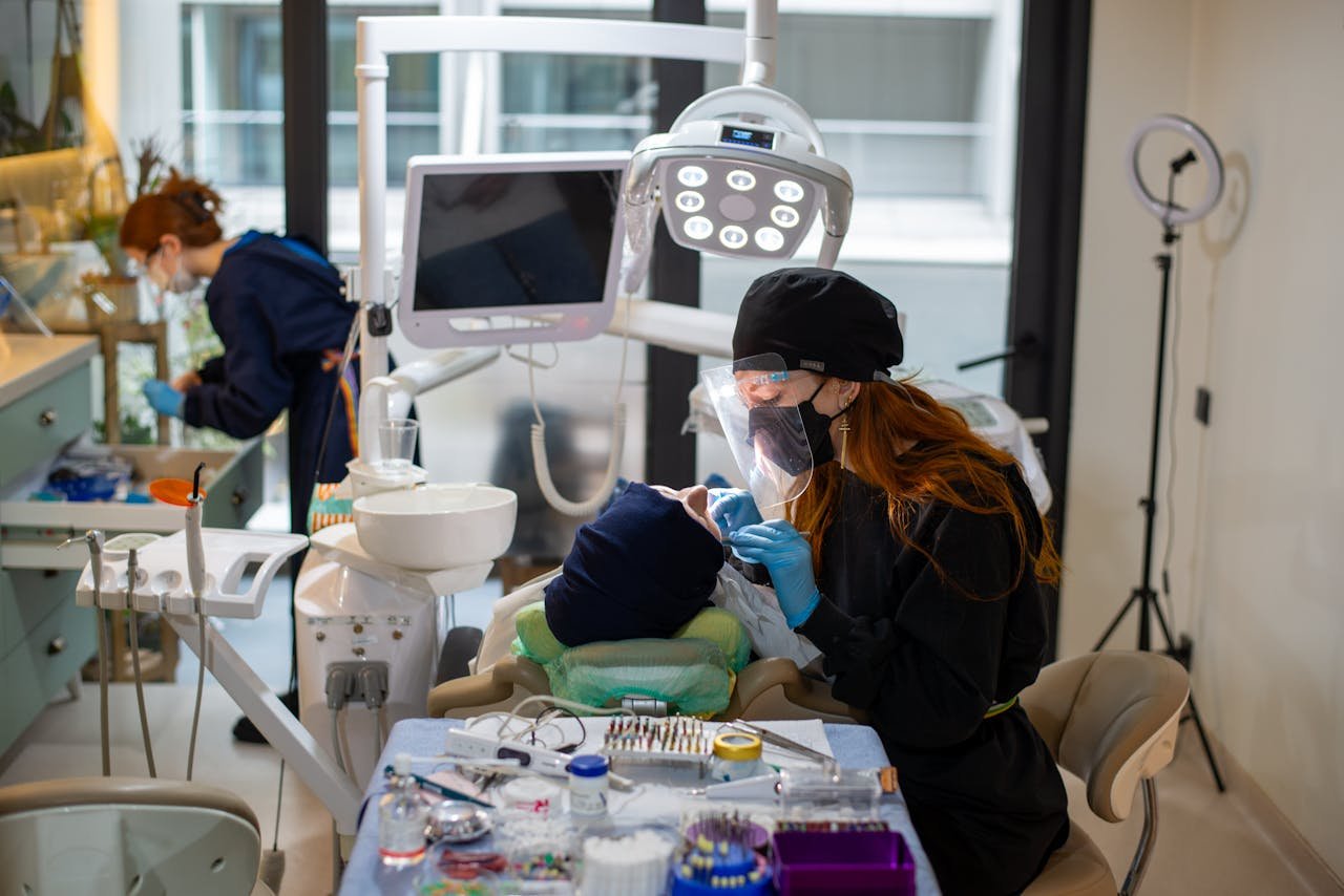 Dentist performing a checkup in a modern clinic, utilizing advanced tools and technology.